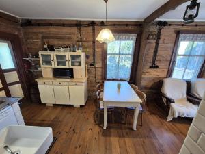 a kitchen with a table and a microwave at Dom Dziadka in Janów Podlaski +37 photos