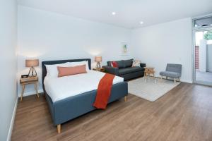 a bedroom with a bed and a living room at Loxton Courthouse Apartments in Loxton