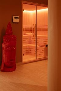 a red sculpture in a room with a mirror at Sol Boutique Hotel in Vlorë