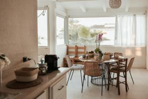 a kitchen with a table and chairs and a window at Fronte Mare Polignano a Mare in Polignano a Mare