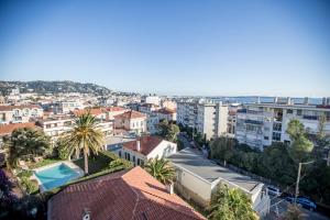 a view of a city with a swimming pool and buildings at Eden by Connexion in Cannes