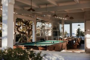 a pool table on the patio of a restaurant at Fronte Mare Polignano a Mare in Polignano a Mare