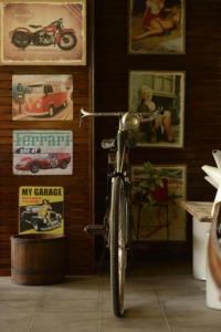 a bike parked in a room with posters on the wall at River Jam Amphawa in Amphawa