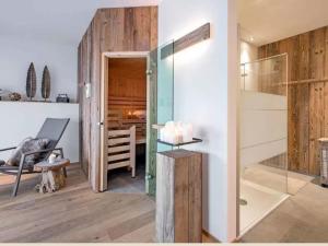 a room with a glass door and a chair and a table at Bergheim Plose - Appartements in St Andrä bei Brixen in Bressanone +92 photos