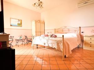 a bedroom with a bed and a table at Bed and Breakfast Nefer in Maratea