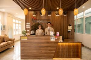 two men standing at a counter in a store at The Morris City Central Boutique in Da Lat +18 photos