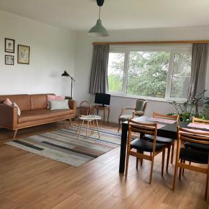 a living room with a couch and a table at De Notelaar in Kortessem