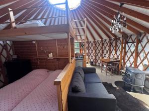 a room with a large bed in a yurt at Halvorseth in Prestfoss