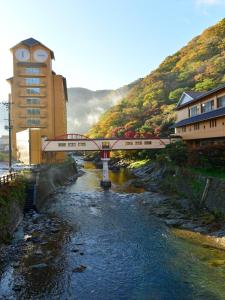 a bridge over a river with a train on it at Yuze Hotel in Kazuno