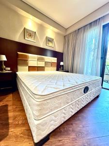 a large white bed in a bedroom with a window at Beach Dreamland Oasis in Chakvi +89 photos