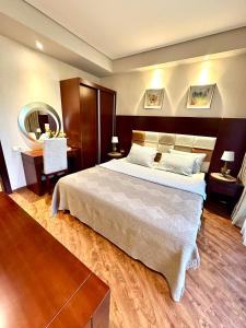 a bedroom with a large bed and a mirror at Beach Dreamland Oasis in Chakvi