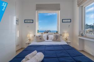 a bedroom with a large bed with a large window at Casa Leucosia Suites in Capri