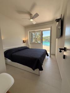 a bedroom with a bed and a view of the ocean at Apartments Gita in Zavalatica