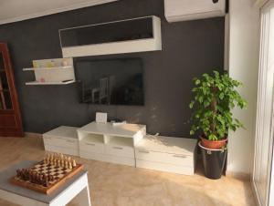 a living room with a large mirror and a table at Piso Almería playa in Almería