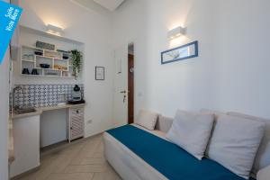 a living room with a couch and a kitchen at Casa Leucosia Suites in Capri +15 photos