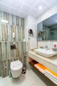 a bathroom with a toilet and a sink at Grand Şeker Hotel in Side +63 photos
