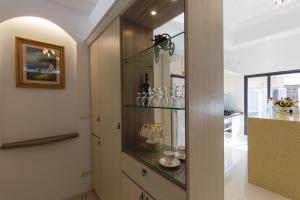 a room with a glass shelf with wine glasses at Creekside No.22 B&B in Jiali