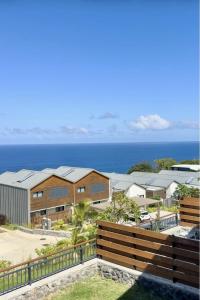 a view of the ocean from a house at Le Loft Bleu in Petite Île