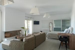 a bedroom with a bed and a living room at Chrysalis Nature Villa 8 in Kampos Paros