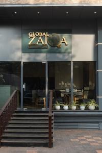 a restaurant with a sign on the front of a building at The Grand Central in Dona Paula