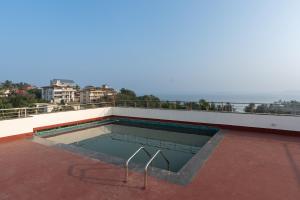 a swimming pool on the roof of a building at The Grand Central in Dona Paula