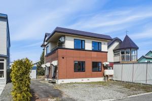 a brick house with a turret on a street at Silvale in Kami-furano