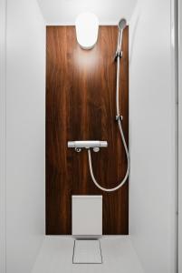 a shower in a bathroom with a wooden wall at Silvale in Kami-furano +67 photos