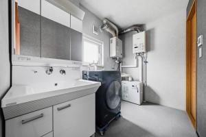 a kitchen with a washing machine and a sink at Silvale in Kami-furano