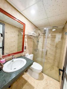 a bathroom with a toilet and a sink and a shower at Liberty Sapa Hotel in Sapa +77 photos