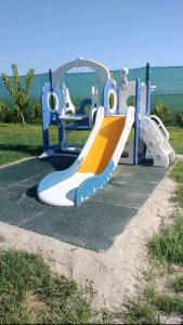 a slide at a playground with the ocean in the background at Wild Serenity in Vadu