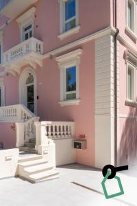 a rendering of a pink house with a green arrow at Hotiday Castiglioncello Suite in Castiglioncello