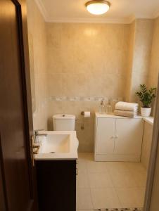 a bathroom with a white sink and a toilet at Piso Almería playa in Almería +13 photos