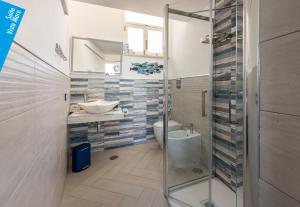 a bathroom with a toilet and a sink and a shower at Casa Leucosia Suites in Capri