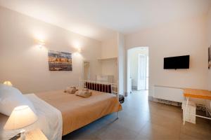 a bedroom with a bed and a flat screen tv at Garibaldi 54 in Bari