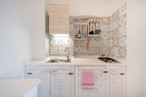 a kitchen with white cabinets and a sink at Garibaldi 54 in Bari +35 photos