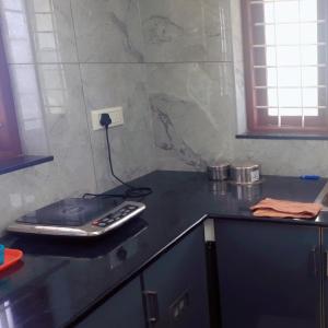 a kitchen counter with a cell phone on top of it at Lazars homestay in Fort Kochi