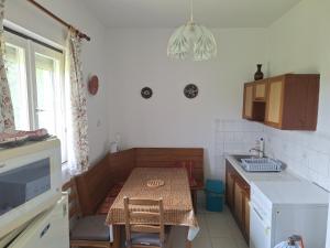 a kitchen with a small table and a table and chairs at Gergócs Vendégház in Őriszentpéter