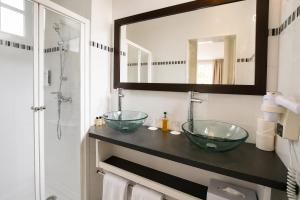 a bathroom with two glass sinks and a shower at Hôtel Villa Flornoy Pornichet Baie de la Baule in Pornichet +20 photos