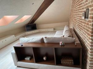 a living room with a couch and a brick wall at Villa Simona in Voghera