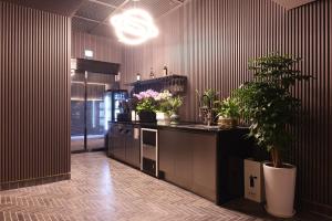 a kitchen with a counter with potted plants on it at Seocho JS Hotel in Seoul