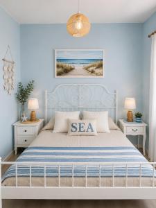 a blue bedroom with a bed and two night stands at Happy House in Kranevo