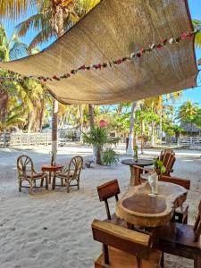 a group of tables and chairs on the beach at Hacienda Antigua Villa, 50m from sandy Beach in El Cuyo