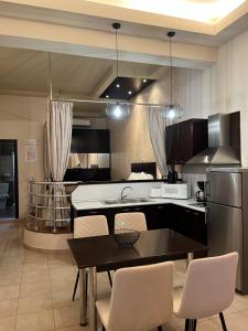 a kitchen with a sink and a table with chairs at Bay View in Faliraki