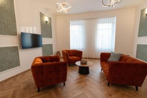 a living room with two couches and a tv at Jancsó Apartman in Dunaföldvár