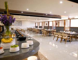 a dining room with tables and chairs and a buffet at Omkar Jungle Resort & Spa, Sirsi in Islūr