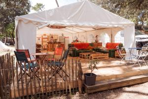 a white tent with chairs and a table at Le Spot Saint-Trojan in Saint-Trojan-les-Bains