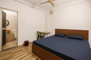 a bedroom with a large bed and a mirror at Residence Inn in Patna