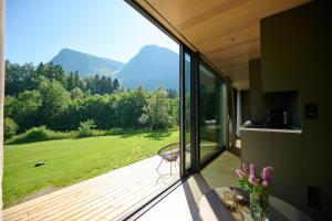a room with a balcony with a view of mountains at Hytte Grøtdalstind, Rekkedal Gjestegard - Sæbø in Sæbø