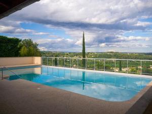 a swimming pool with a view of the countryside at gite villa ardeche joyeuse piscine in Joyeuse