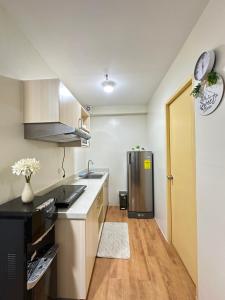 a kitchen with a sink and a refrigerator at Te Haven in Davao City